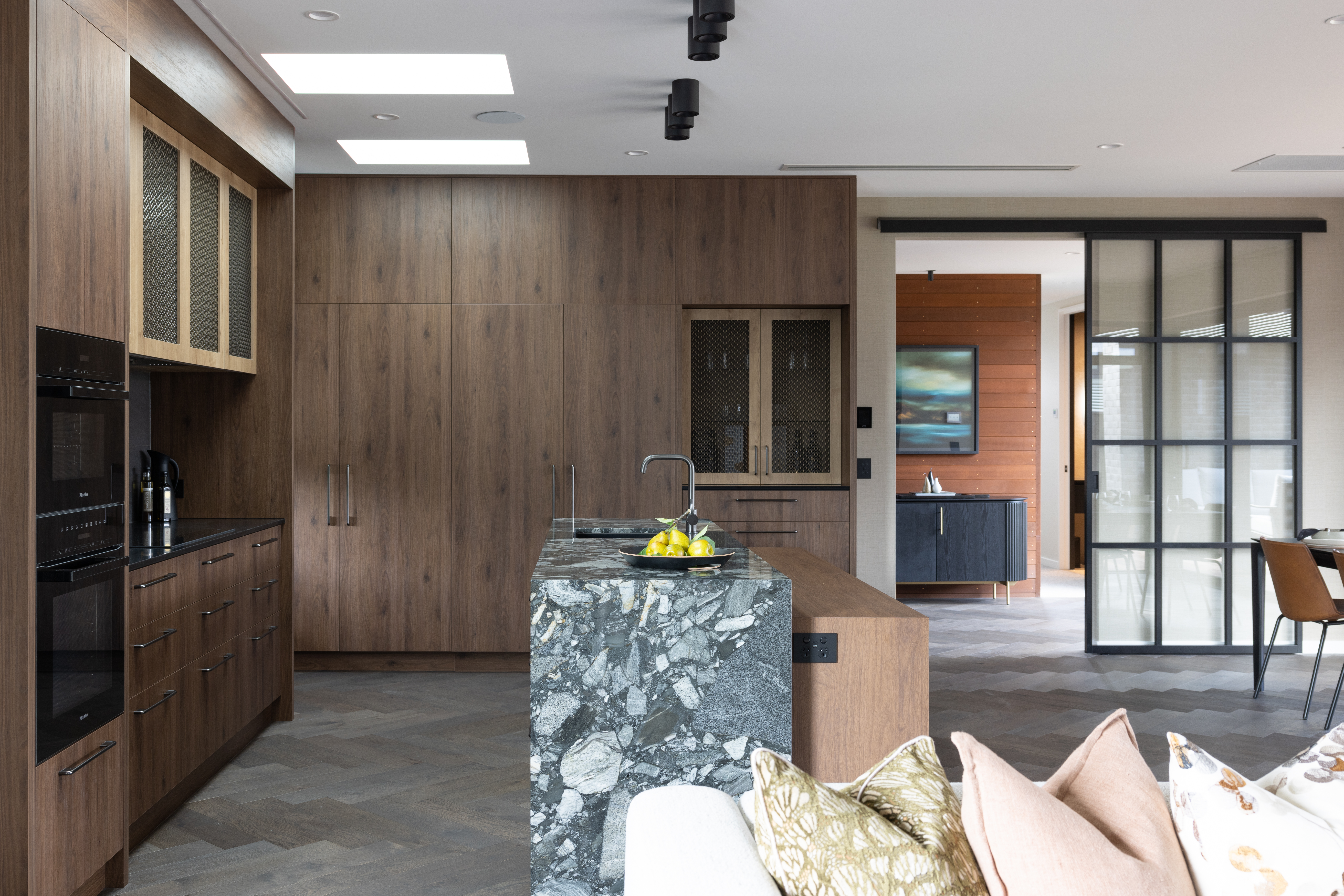 This image showcases a kitchen project featuring a Staten Brushed Brass Wovenpanel by Archant