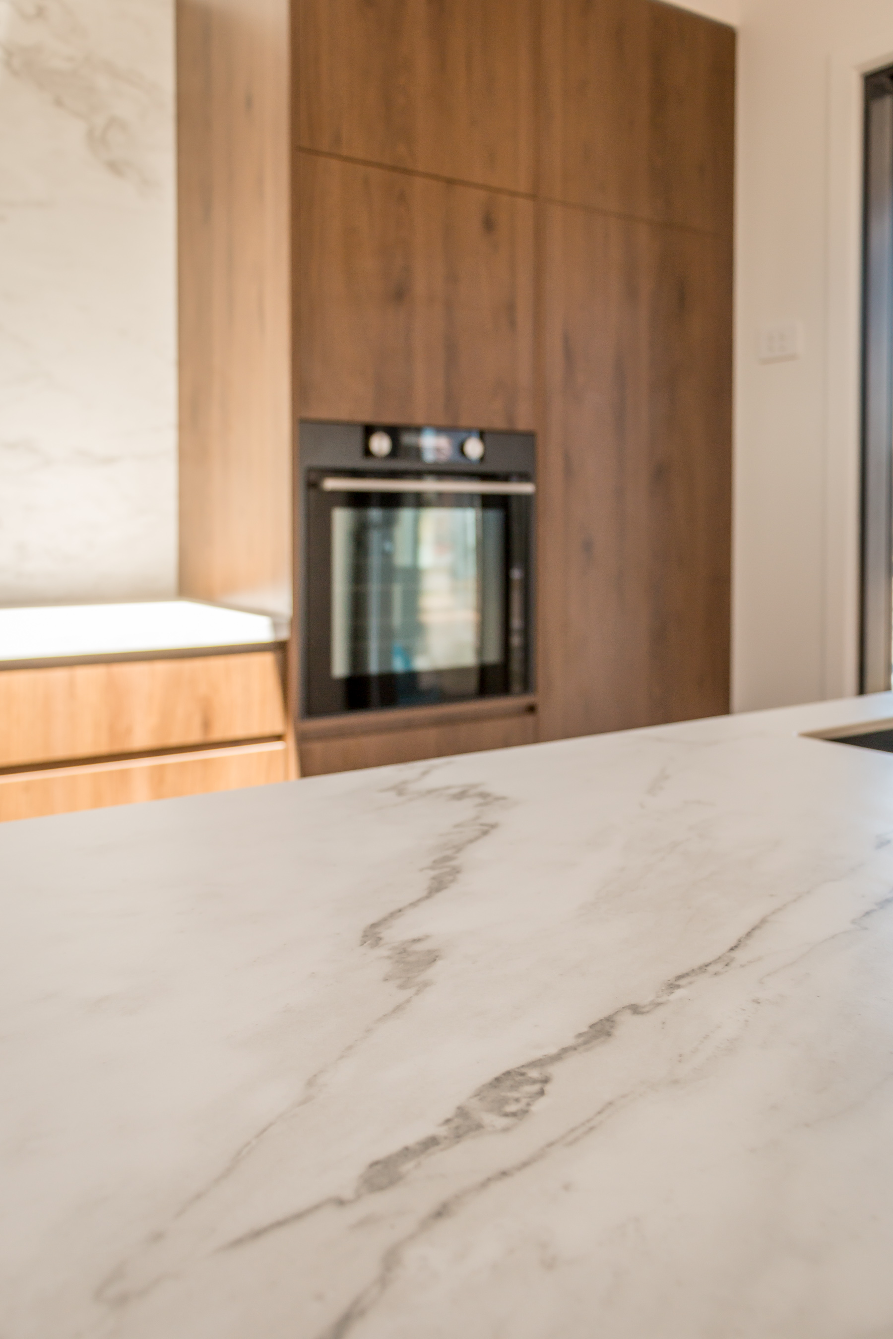 This image showcases a kitchen project featuring a Florim Stone Marfil